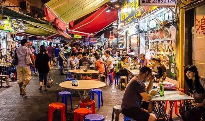 people eating at the open stalls