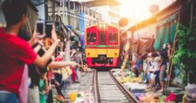 A train in Thailand passing through the market