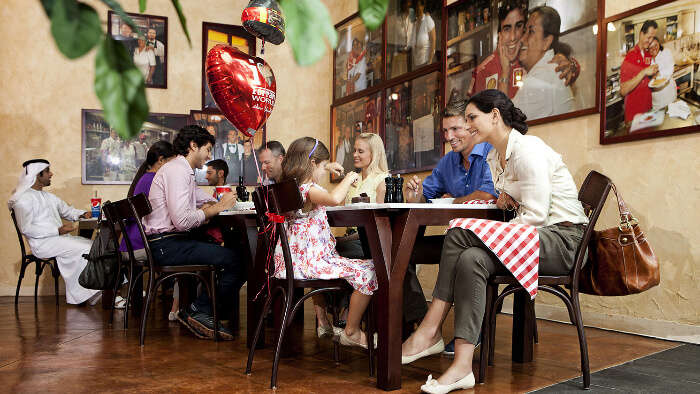 A family enjoying food at a restaurant in Ferrari World