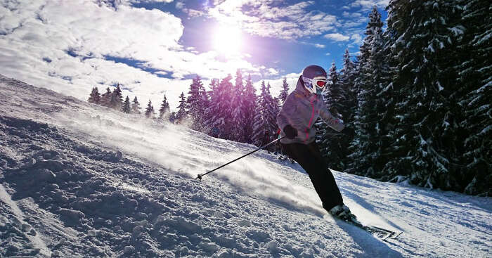 A person skiing on the icy slope of a mountain