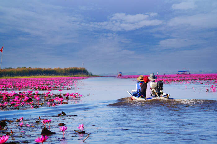 tourists on a boat in udon thani