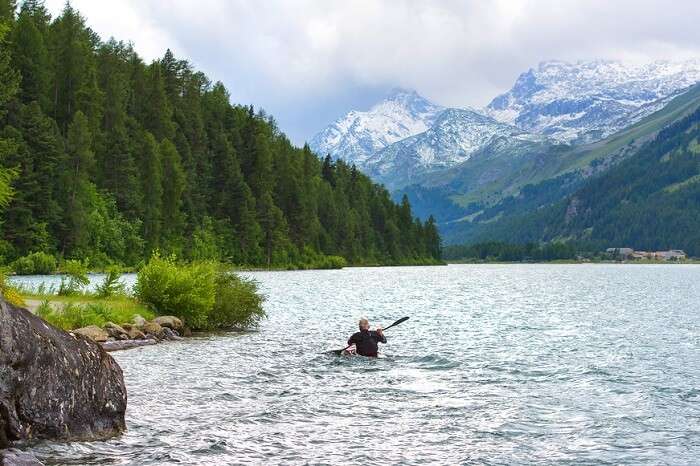 man kayaking in the river in switzerland