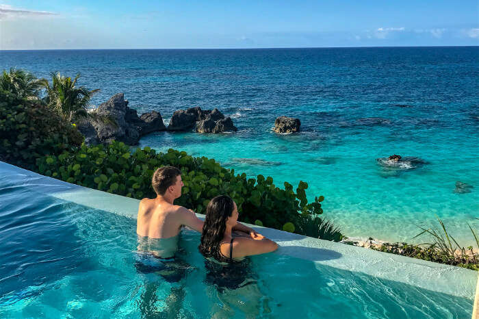 couple in a swimming pool with a view