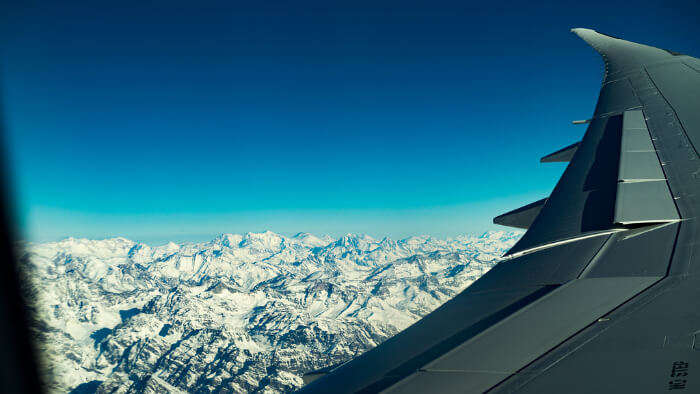 Take A Flight Over Snow Capped Mountains