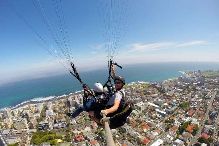 man paragliding in sky