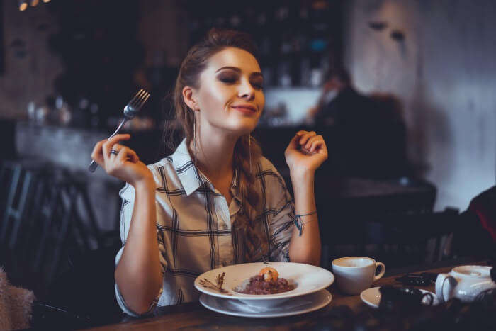 girl eating food in a restaurant