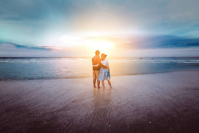 young couple standing on a beach