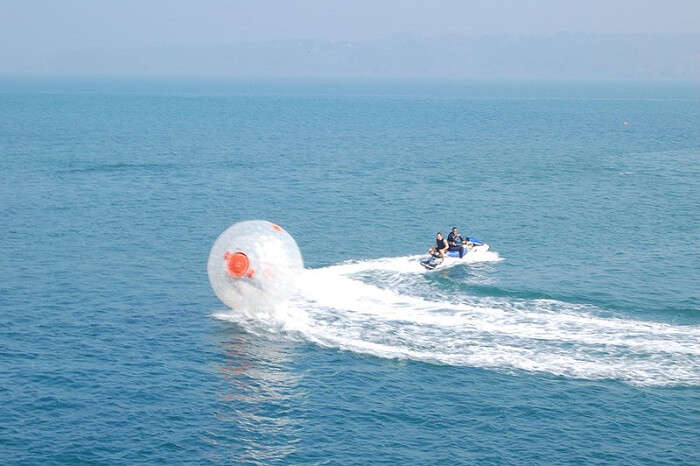 person riding a zorbing ball