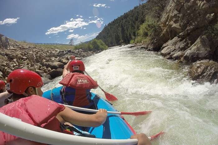 person rafting the boat in speed
