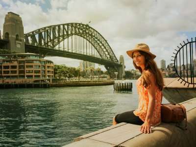Girl sitting in front of harbour bridge