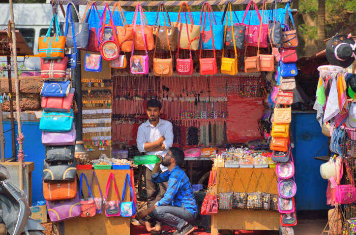 Portrait of beautiful traditional Indian seller business woman in red sari  dress with customer in street Delhi market india mumbai.Happy girl shopper  in a supermarket fruits vegetable shop Kerala Goa. Stock Photo |