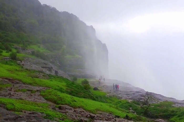 People standing near reverse waterfall