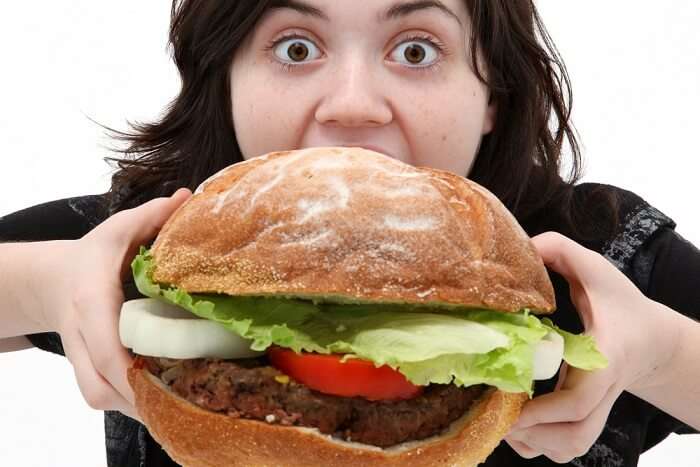 woman eating giant burger