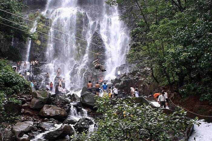 people doing activities near waterfall