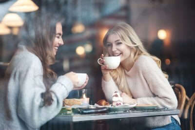 women drinking coffee in cafe