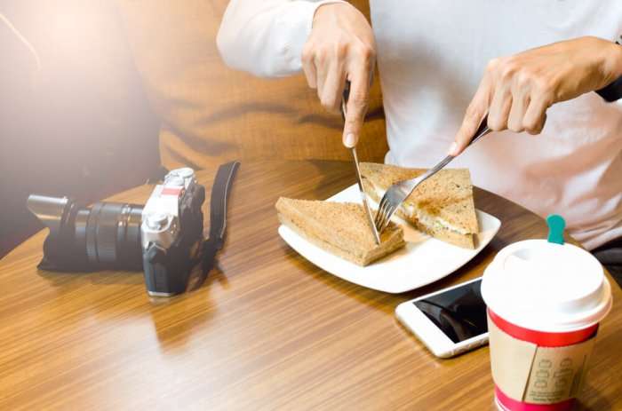 A guy eating in a restaurant