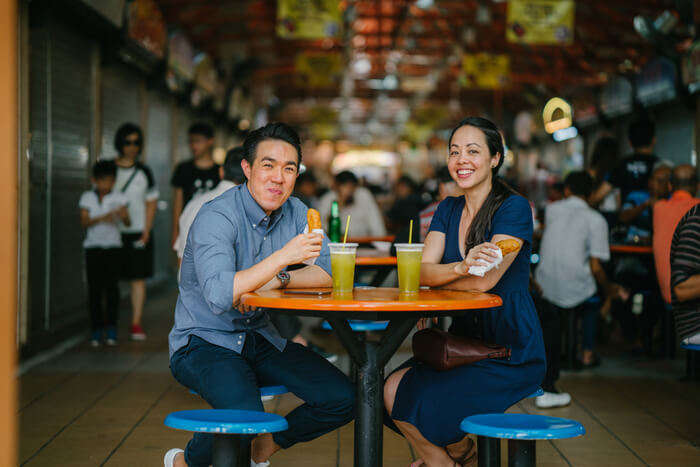 An Asian couple drinking in a cafe in Singapore
