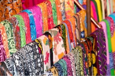 stoles hanging in a market in bali