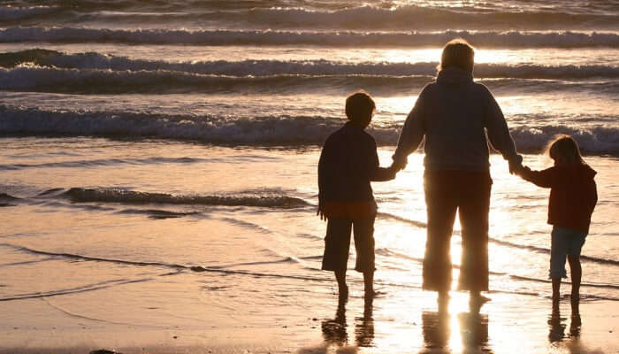 woman with kids at a beach