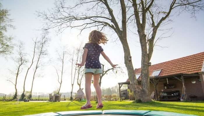 little girl jumping on trampoline