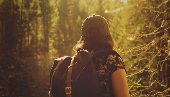 A girl trekking through the forest