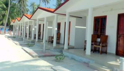cottages on a beach at one of the Lakshadweep hotels