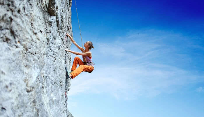 A woman enjoys rock climbing adventure
