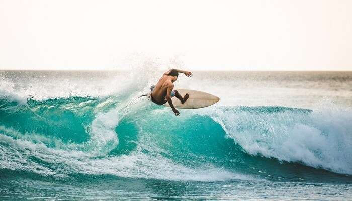 professional surfer riding waves in Bali, Indonesia. men catching waves in ocean, isolated. Surfing action water board sport. people water sport lessons and beach swimming activity on summer vacation