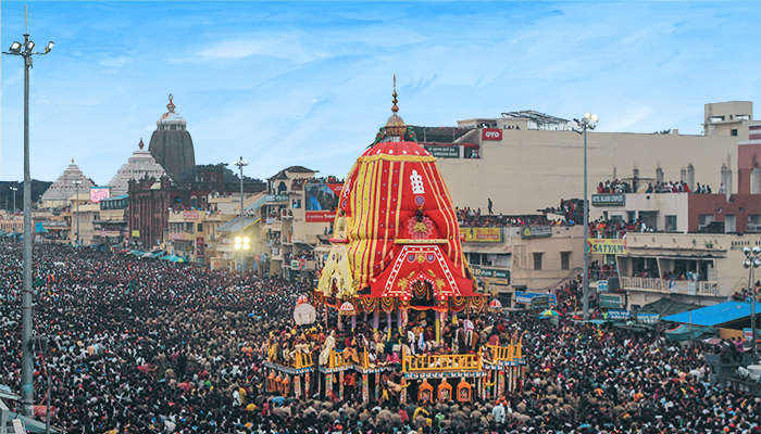 Vibrantly decorated wooden chariots of Lord Jagannath, Balabhadra, and Subhadra ready for the grand Rath Yatra procession in Puri, Odisha, 2025, with devotees gathered around in colourful attire.