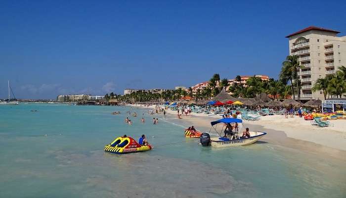 The luxurious beaches of Aruba are one of the best places to visit in July in the world to beat the summer heat and relax.