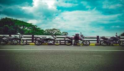 A man sitting looking at the views on his road trip from Kerala