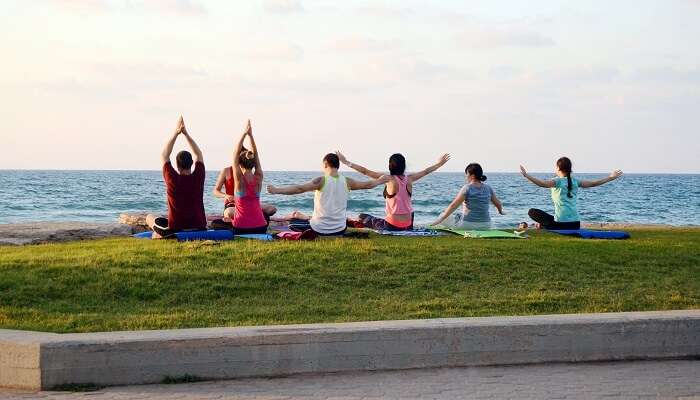 Practice yoga on a beach, among free things to do in Dubai