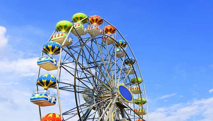 Enjoy the giant wheel and hanging around in a fair at Race Course Ground in Rajkot