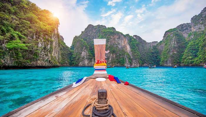 Scenic view of long boat and blue water at Maya Bay in Phi Phi Island