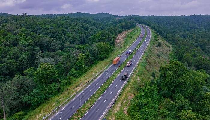 Aerial View Of Road Going Through Greenery