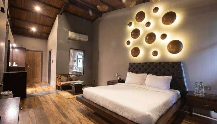 Cozy bedding and plush interiors at Encore, a boutique resort in Mulshi for couples