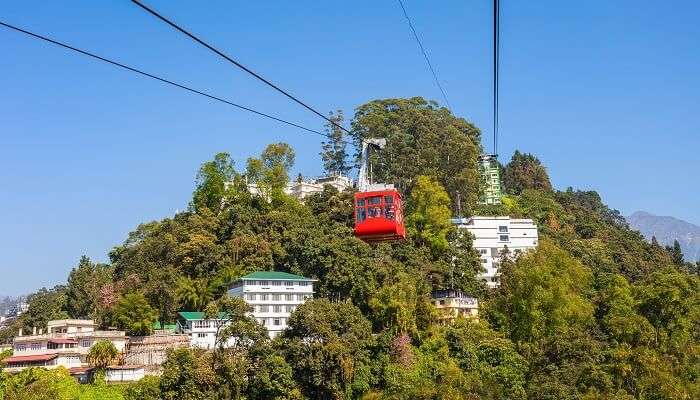 Tourist enjoying cable car ride at one of the best places to visit in India