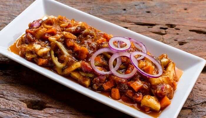 Try the delicious Sri Lankan pickle garnished with onions for a satisfying meal. 