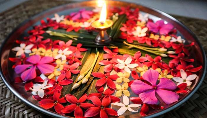 A picture of Aarti Thali with fresh flowers and ghee lamp diya that you can find in religious tourist places in Pudukkottai