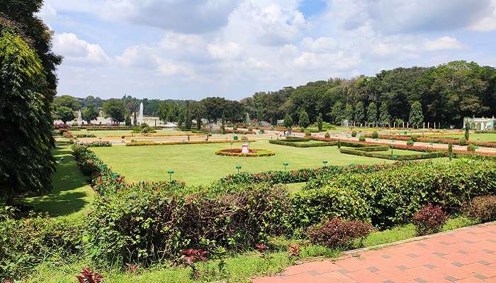 A sunny view of the lush green Brindavan Gardens, one of the top attractions near Maddur
