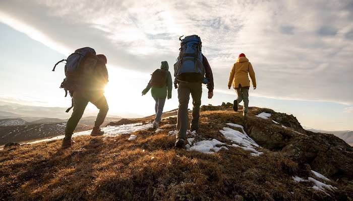 Hikers with backpacks while hiking, one of the bucket list ideas for summer.