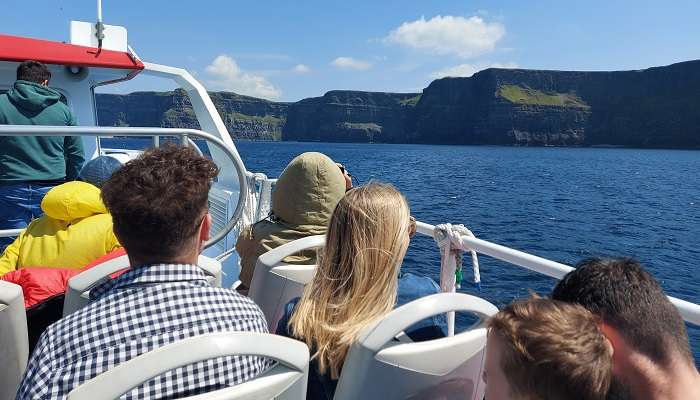 An amazing view of People watching the mesmerizing view of the Cliffs of Moher in Ireland