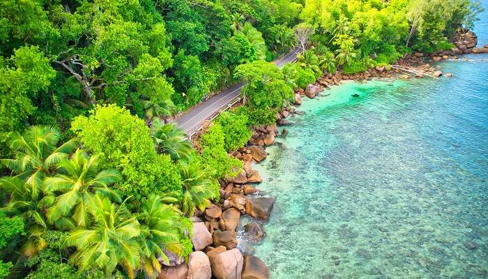 The bird eye drone of Baie Lazare beach, granite stones, turquoise water, and more where one of the best hotels in Seychelles, Kempinski Seychelles Resort, is situated. 