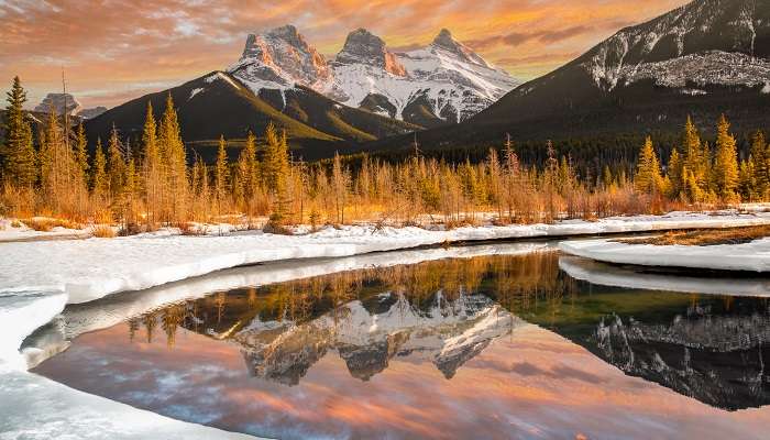 A surreal scene of sunset at Three Sisters in one of the small towns in Alberta, Canmore