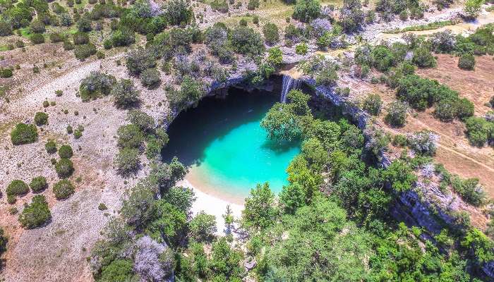 The picturesque aerial view of Hamilton Pool Preserve, nestled in one of the small towns in Texas, Dripping Springs