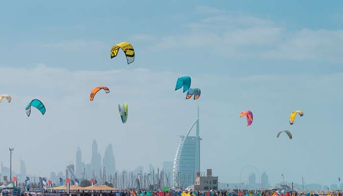 A view of colourful kites, belonging to Kite surfers, over the private beach in Dubai, Kite Beach.