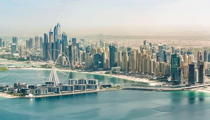The scenic view of Dubai Marina skyline from the famous private beach Dubai, Palm West Beach.