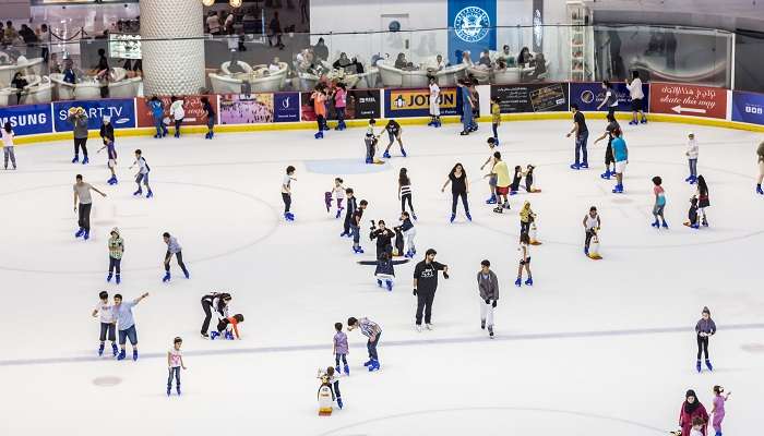 Children and adults enjoying ice skating in Dubai.