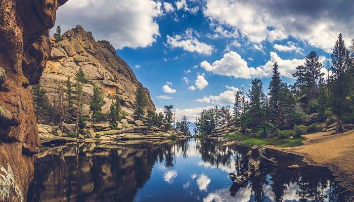 The perfectly still water on Gem Lake in Estes Park, among the best small towns in Colorado.
