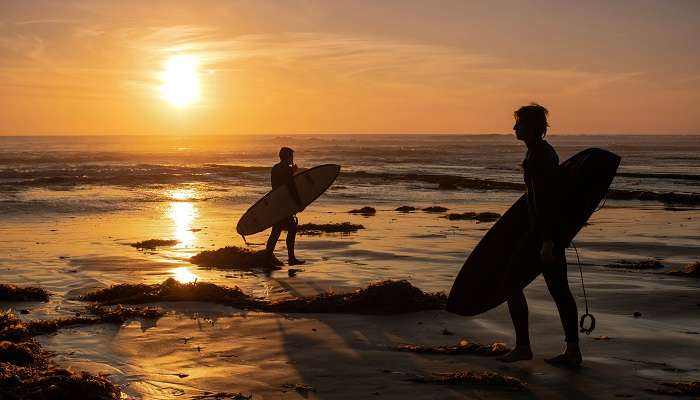 Surfers on Swami’s Beach, among the best hidden gems in San Diego